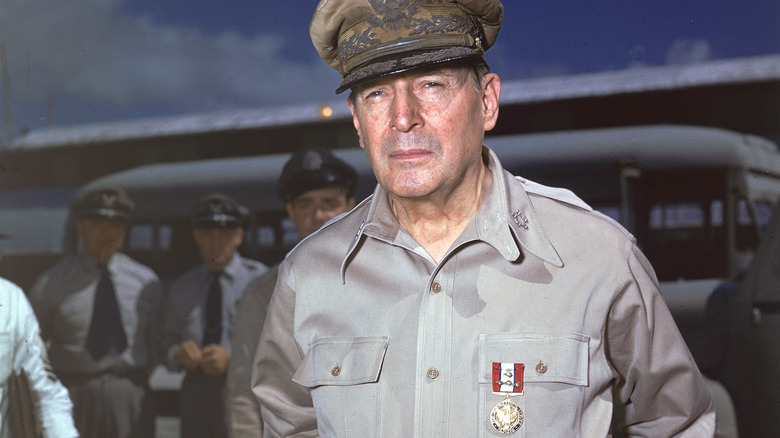 Douglas MacArthur stands on a runway