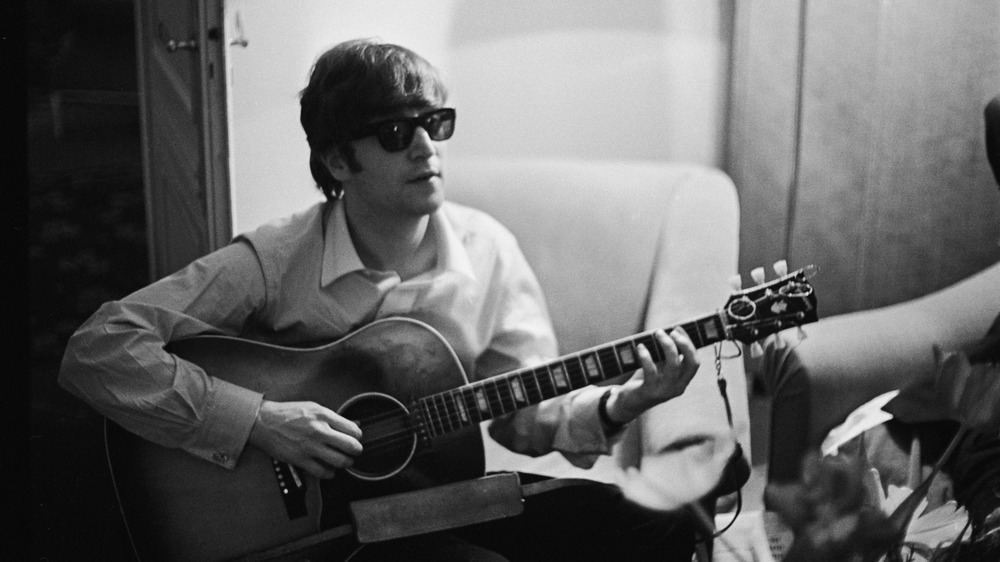 John Lennon playing guitar
