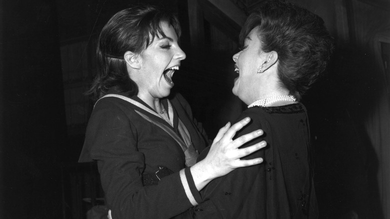 Judy and Liza laughing on stage