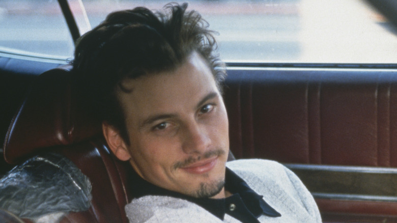 Skeet Ulrich leans on car seat