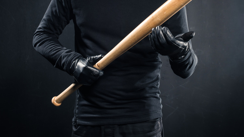 Criminal holding baseball bat