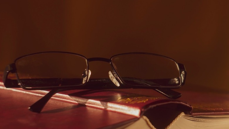 overturned book and glasses