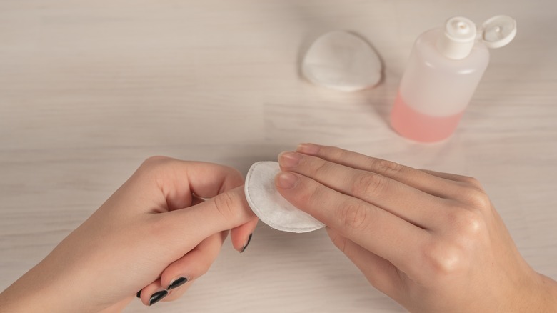 woman removing nail polish