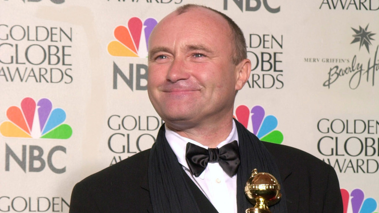 Phil Collins holding award