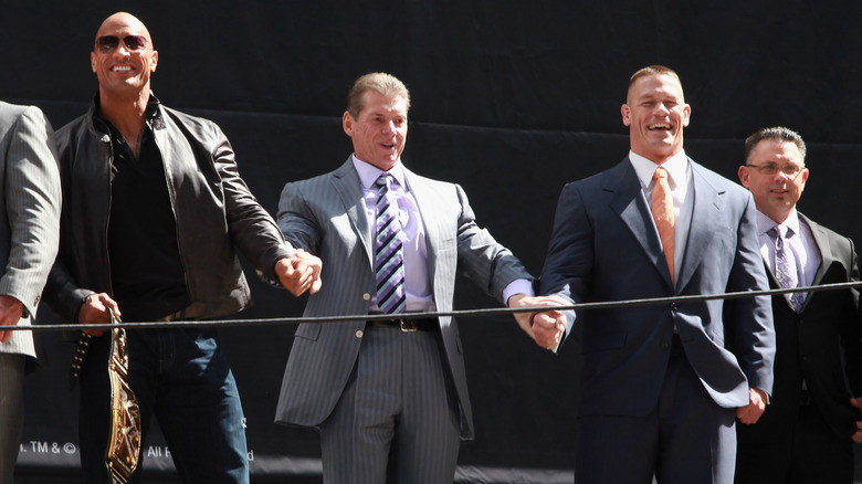 Vince McMahon raising Rock and Cena's hands
