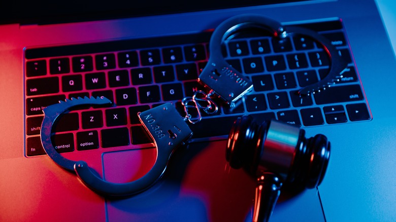 gavel on laptop with handcuffs