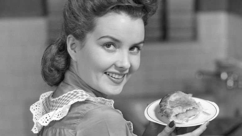 woman holding plate of pie