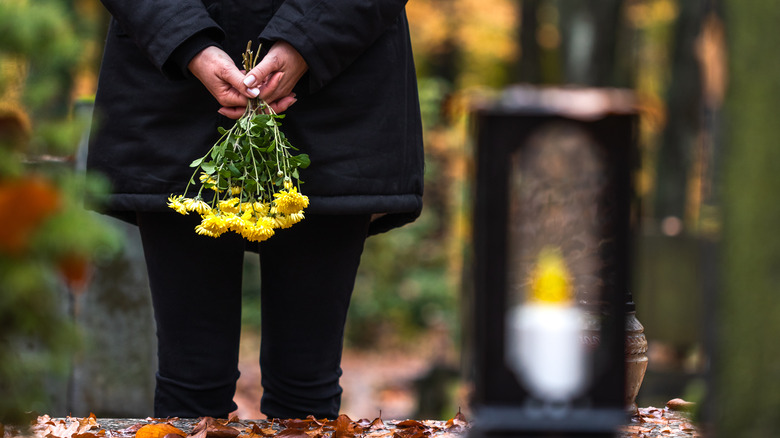 woman holding yellow flowers