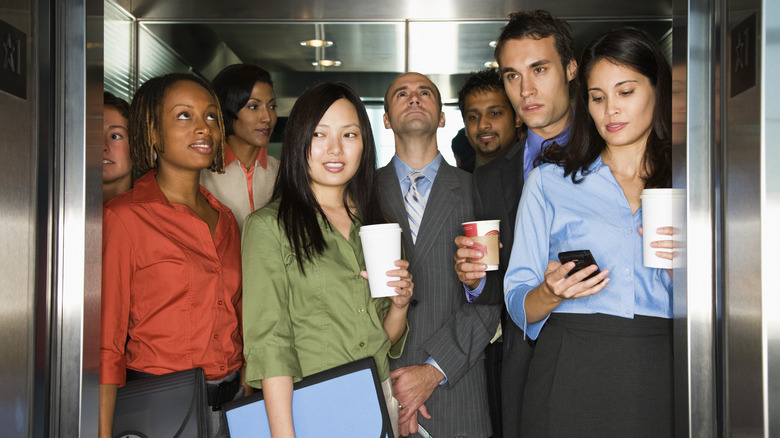 Office people packed into elevator