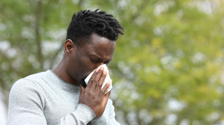 a child blowing his nose