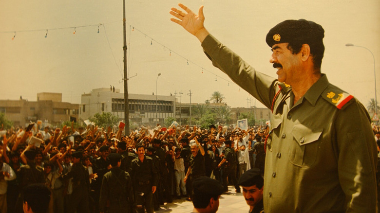 Saddam Hussein welcoming troops