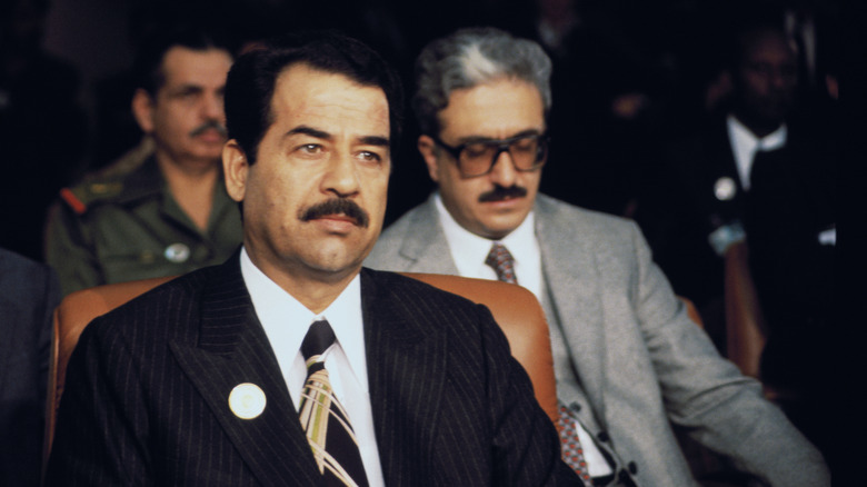 Saddam Hussein sitting in chair