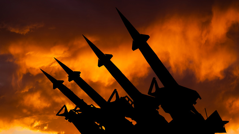 Silhouetted missiles point up