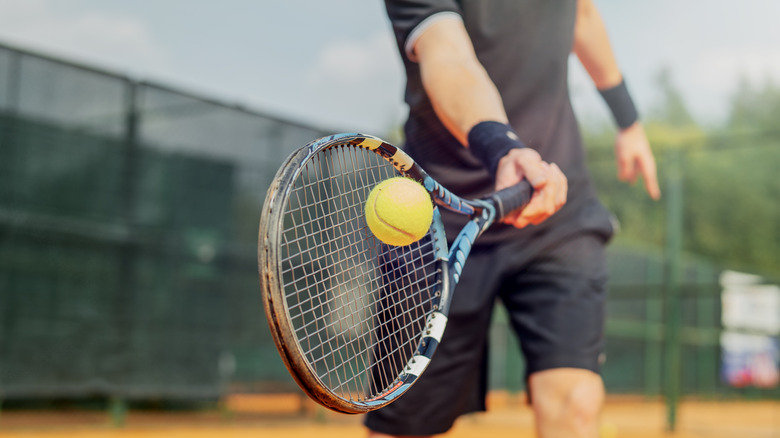 Man hitting tennis ball