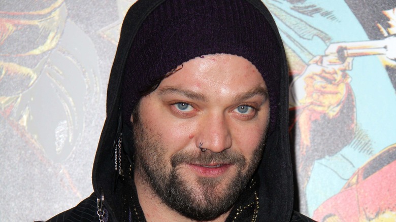 Bam Margera smiling wearing a black hood