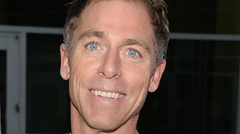 Dave England smiling blue eyes dark background