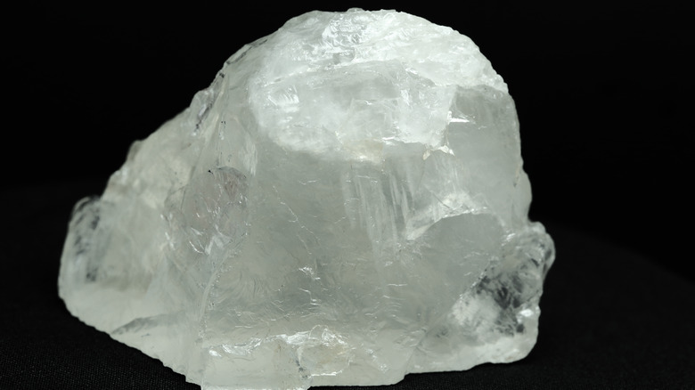 A solid rock quartz crystal against black