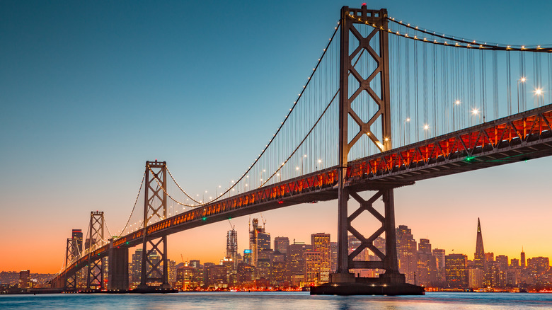 Oakland Bay Bridge illuminated in beautiful golden evening light at sunset in summer, San Francisco Bay Are