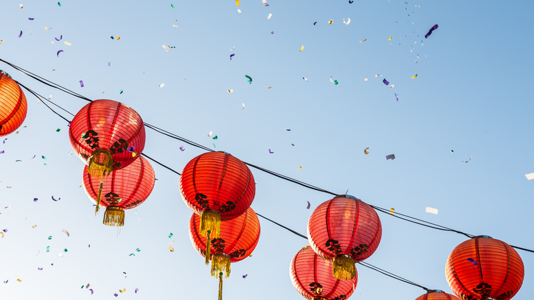 Red lanterns strung across a courtyard between buildings in the Chinatown district in Los Angeles, California, USA