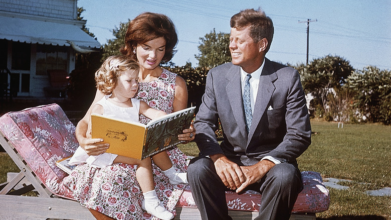 JFK and family reading outside