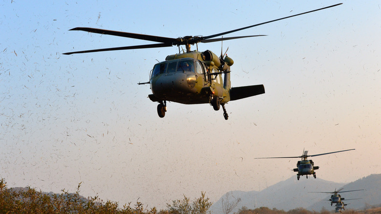 Military helicopters flying in formation