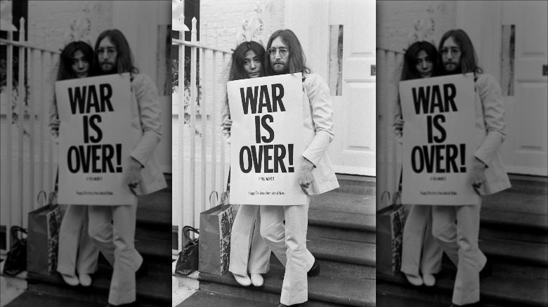 Lennon and Ono with War is Over sign