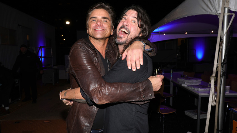 John Stamos and Dave Grohl hugging 