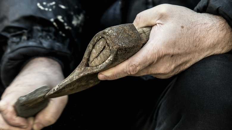 Mans hands with an ax