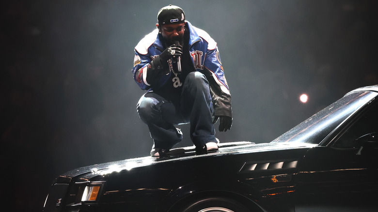 Kendrick Lamar performing on a car at the Super Bowl