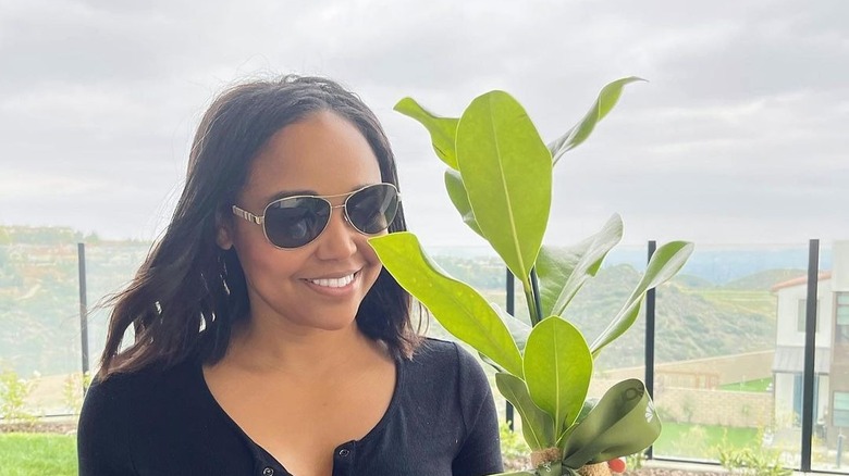 Faith Jenkins outdoors with plant
