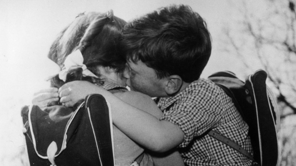 Boy gives girl a kiss on the cheek