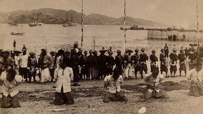 Kowloon pirates kneeling to be beheaded