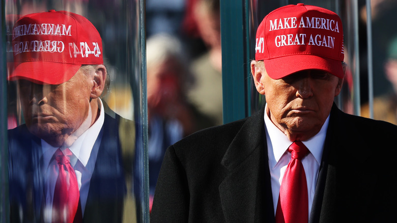 Donald Trump is reflected in glass