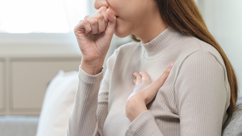 Young woman coughing