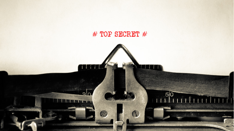 typewriter with top secret in red ink