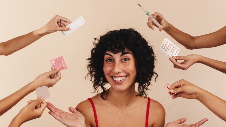 Woman surrounded by birth control 