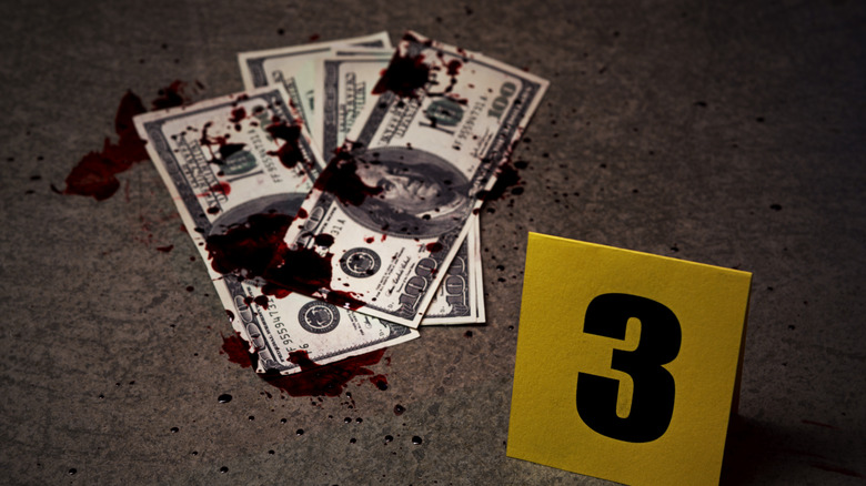 Crime scene marker with bloody money