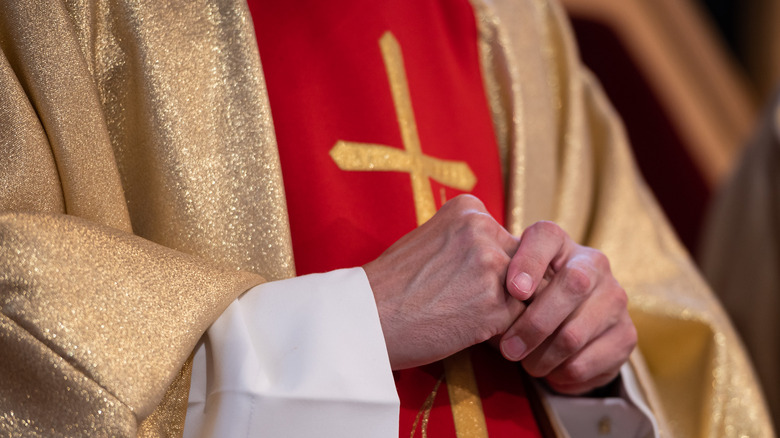 Catholic priest in red cassock