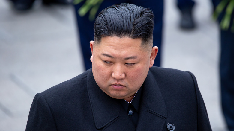 Kim Jong-un unsmiling in black overcoat