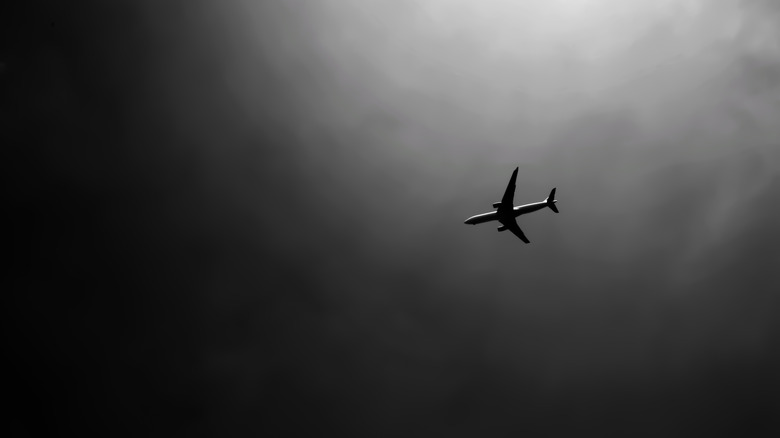 Boeing-777 flying in grey sky