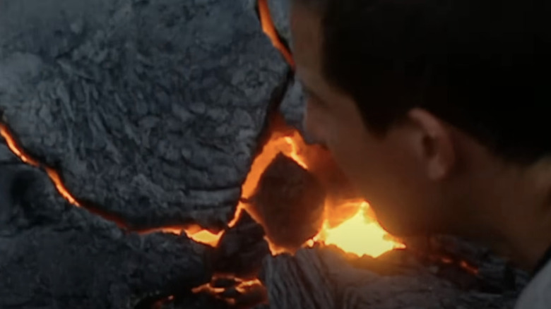 bear grylls looks at magma rocks