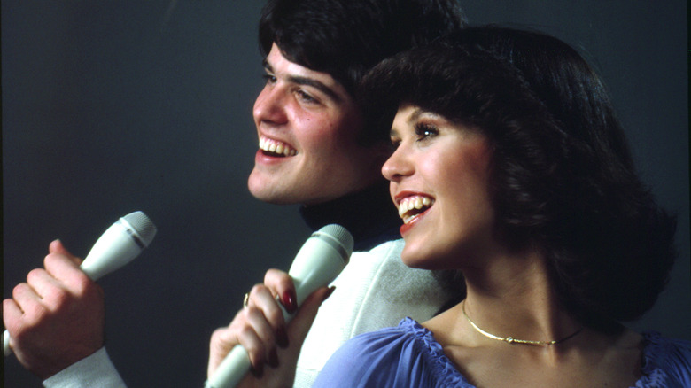 Marie and Donny Osmond with mics