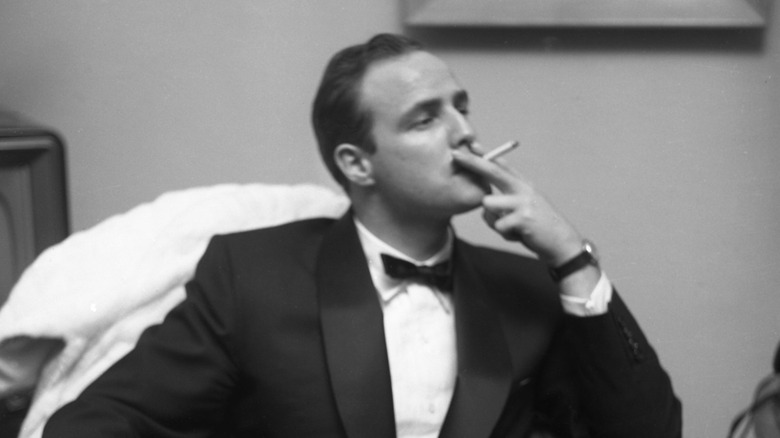 Marlon Brando smoking in a tuxedo