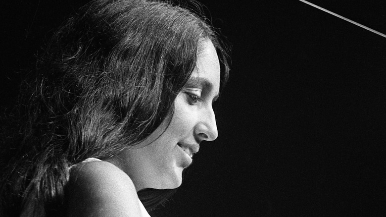 Joan Baez smiling onstage at Newport Folk Festival