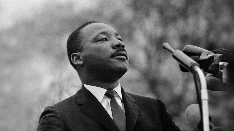 Martin Luther King, Jr. with head held high at podium