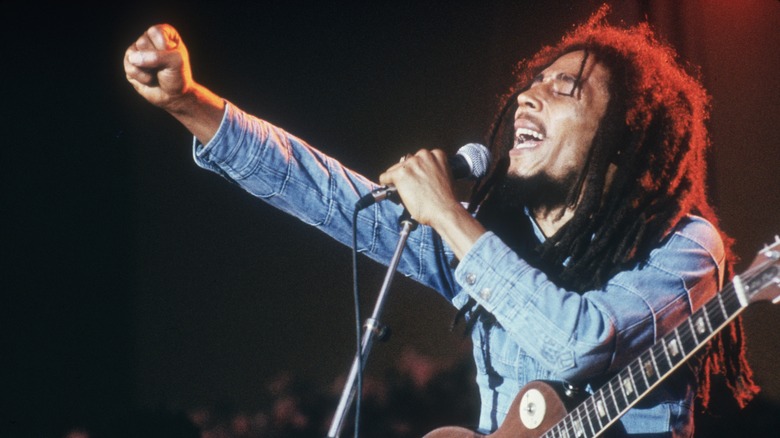 Bob Marley raising a fist while singing onstage