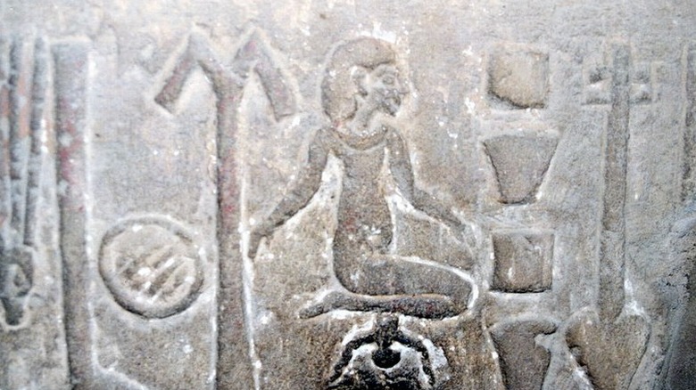 Ancient Egyptian hieroglyph woman giving birth