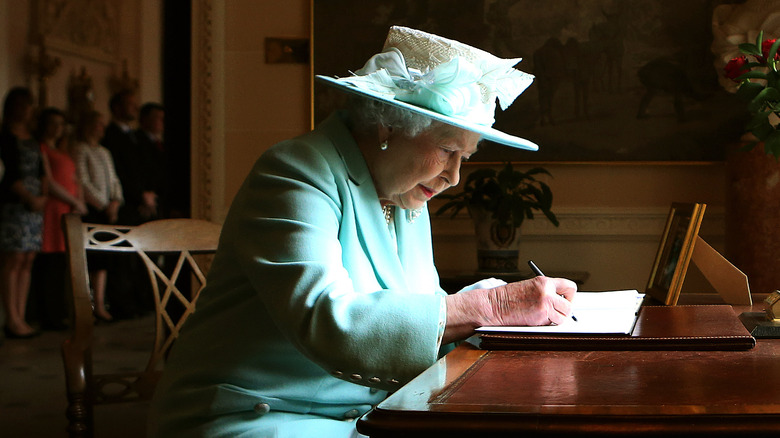 Queen Elizabeth II writing