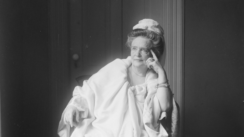 Ann O'Delia Diss Debar portrait, sitting in white