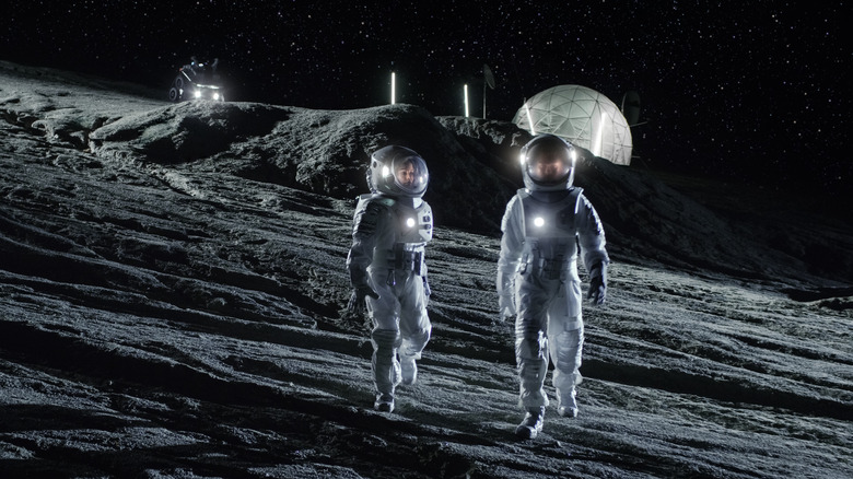 two astronauts walking on a foreign planet